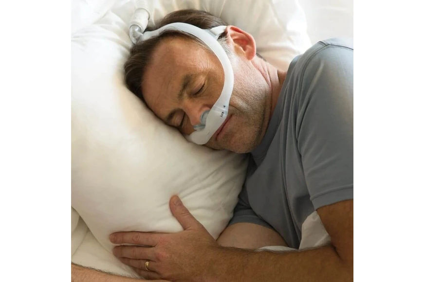 Man sleeping wearing Philips DreamWear Gel Pillow nasal mask, close-up lifestyle shot