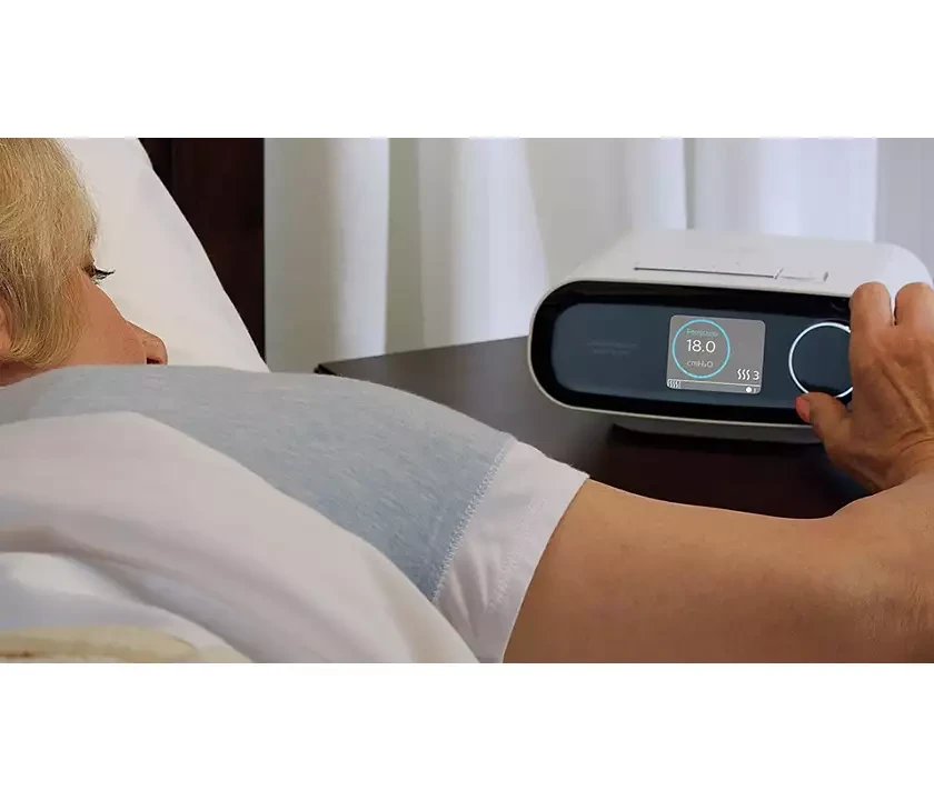 DreamStation BiPAP AVAPS 30 AAM pressure setting of 18.0 cmH2O shown on the device display at bedside