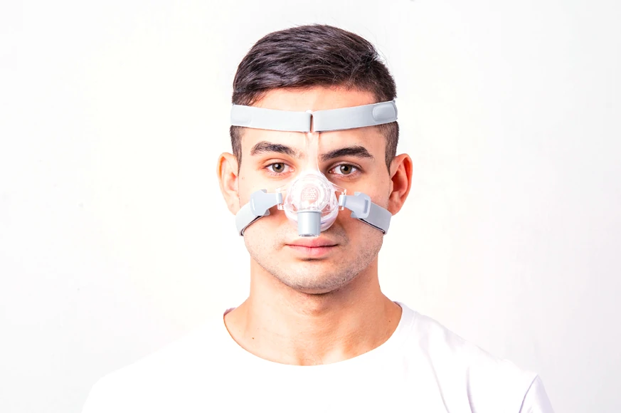 Man wearing BMC N5 nasal mask, front view, white t-shirt, white background