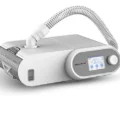 Oxymed SleepEasy Auto CPAP machine, angled view with tubing