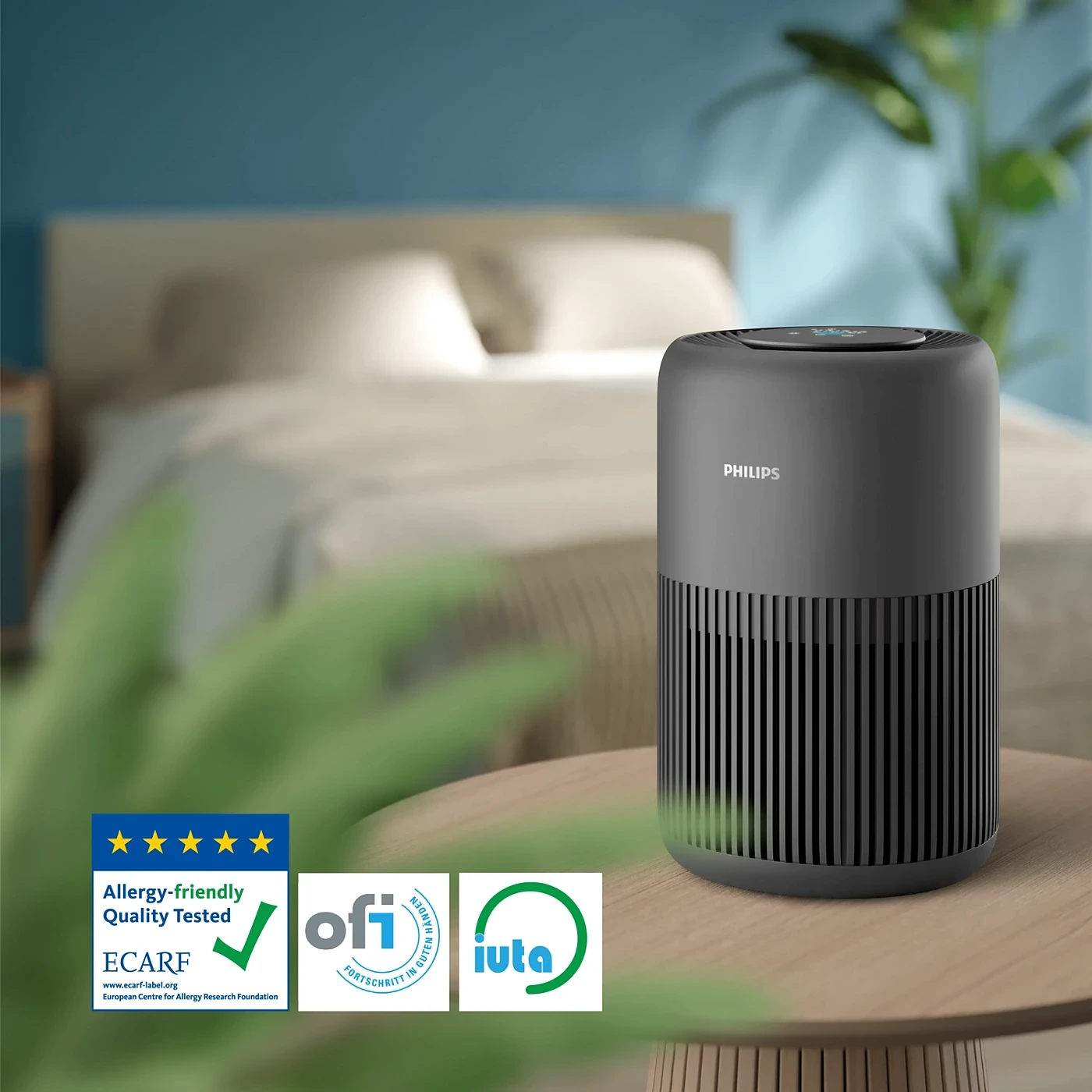 Philips AC0950/60 air purifier on bedside table with ECARF, ofi and iuta certification badges