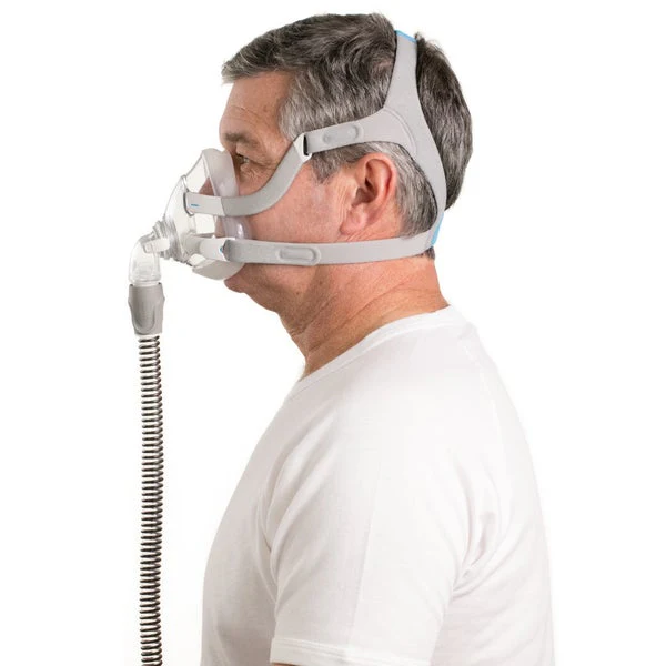 Man wearing ResMed AirFit F20 mask, rear side profile showing headgear strap routing