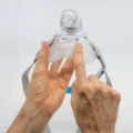 Hands holding ResMed AirFit F20 Medium cushion, showing InfinitySeal silicone cushion and size label