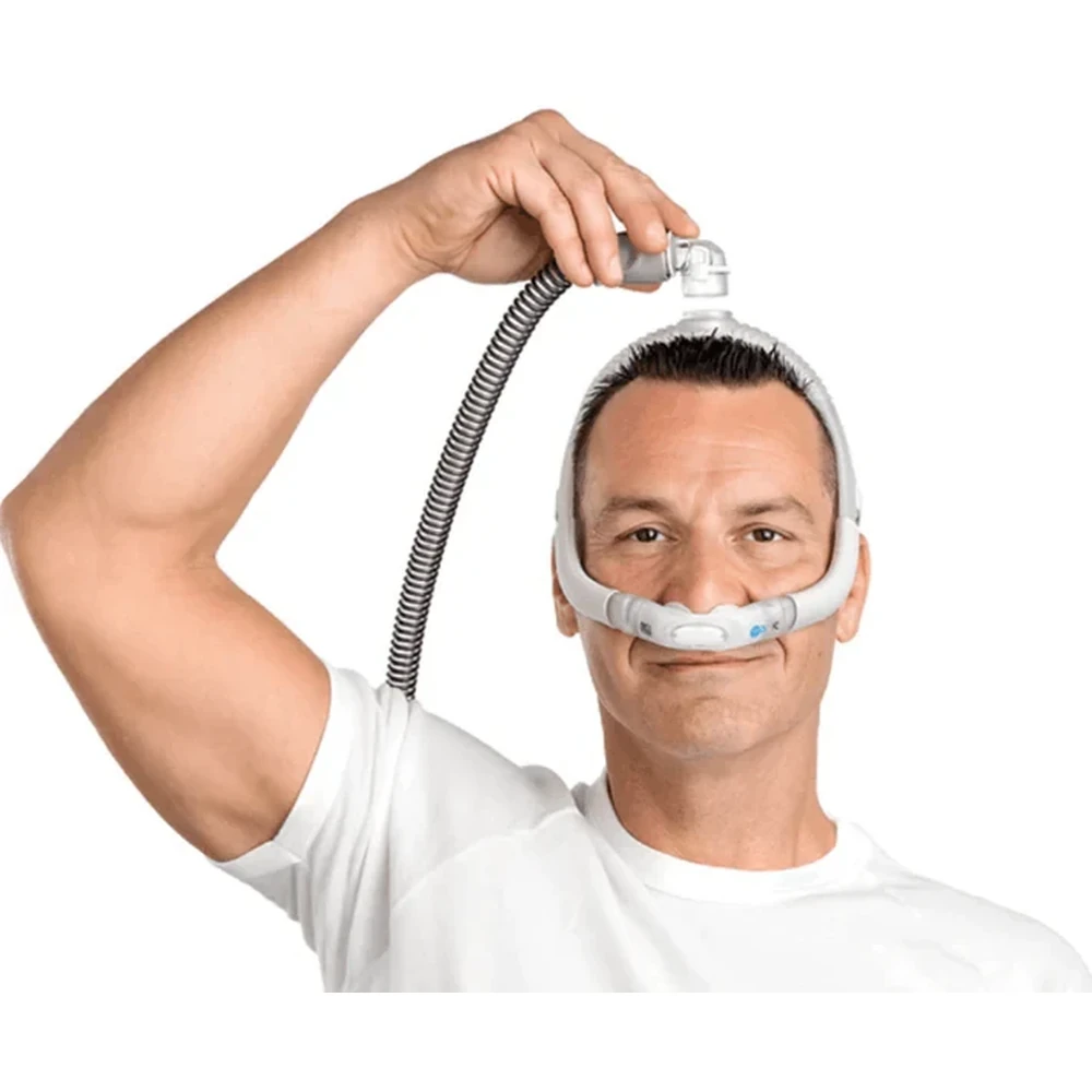 Man holding ResMed AirFit P30i top-of-head tube, demonstrating tube position
